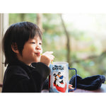 Young child drinking from the Tony the Tiger™ Puzzle Cup, enjoying a fun and interactive drinkware experience.