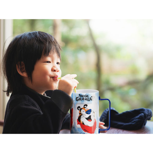 Young child drinking from the Tony the Tiger™ Puzzle Cup, enjoying a fun and interactive drinkware experience.