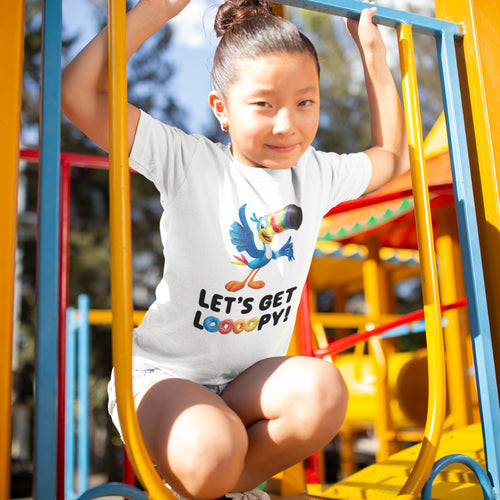 Child playing while wearing the Froot Loops® "Let's Get Loooopy" T-Shirt, featuring Toucan Sam™ and playful cereal graphics.