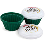 Two green Kellogg's All-Bran® microwave muffin cups with white branded lids, displayed open and closed.